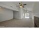 Spacious living room featuring vaulted ceilings, neutral paint, ceiling fans, and a cozy fireplace at 522 W Dennis Ct, Tempe, AZ 85283