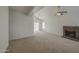 Clean and empty living room featuring vaulted ceilings, neutral paint, ceiling fan and a cozy fireplace at 522 W Dennis Ct, Tempe, AZ 85283