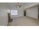 Clean and empty living room featuring vaulted ceilings, neutral paint, ceiling fan and a cozy fireplace at 522 W Dennis Ct, Tempe, AZ 85283