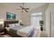 Cozy main bedroom featuring a sliding glass door, a ceiling fan, and neutral decor at 522 W Dennis Ct, Tempe, AZ 85283