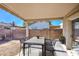 A covered patio with a dining table and chairs, perfect for outdoor entertaining at 522 W Dennis Ct, Tempe, AZ 85283