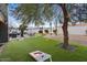 Back yard with artificial turf, mini putting green, mature trees, and an outdoor dining space at 5338 E Hearn Rd, Scottsdale, AZ 85254