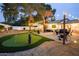 Beautiful backyard with putting green, outdoor seating, string lights, and mature trees perfect for entertaining at 5338 E Hearn Rd, Scottsdale, AZ 85254
