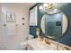 Bathroom with blue walls, gold fixtures, and decorative tile at 5338 E Hearn Rd, Scottsdale, AZ 85254