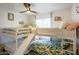 Fun ' bedroom with unique bunk beds with slide, leafy bedding, ceiling fan, and window with natural light at 5338 E Hearn Rd, Scottsdale, AZ 85254