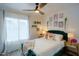 Bright bedroom featuring a plush green bed, decorative pillows, and decorative wall art at 5338 E Hearn Rd, Scottsdale, AZ 85254