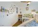 Bright bedroom with a slide bunkbed, wooden shelves, and butterfly wall stickers for a playful atmosphere at 5338 E Hearn Rd, Scottsdale, AZ 85254