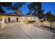 Well-maintained single-story home with clean lines, covered parking, a paved driveway, and xeriscaped front yard at 5338 E Hearn Rd, Scottsdale, AZ 85254