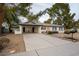 Charming home with carport, xeriscaped yard, clean white exterior, and a newly paved driveway at 5338 E Hearn Rd, Scottsdale, AZ 85254