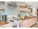 Colorful kitchen with wooden countertops, floral wallpaper, open shelves, and modern appliances for cooking enjoyment at 5338 E Hearn Rd, Scottsdale, AZ 85254