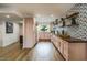 Bright kitchen featuring vintage pink cabinetry, open shelving, wood countertops, and modern appliances at 5338 E Hearn Rd, Scottsdale, AZ 85254