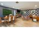 Open living space with dining area, fireplace, accent walls, and wood laminate flooring at 5338 E Hearn Rd, Scottsdale, AZ 85254