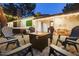 Inviting patio with a fire pit, comfortable seating, hot tub, and string lights perfect for outdoor relaxation at 5338 E Hearn Rd, Scottsdale, AZ 85254