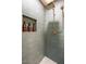 Close-up of shower with decorative tile and gold shower head at 5338 E Hearn Rd, Scottsdale, AZ 85254