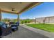 Inviting backyard space featuring a covered patio, artificial turf and outdoor seating at 5516 N 193Rd Ave, Litchfield Park, AZ 85340