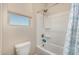 Bright bathroom featuring a tub with a shower and window providing natural light at 5516 N 193Rd Ave, Litchfield Park, AZ 85340