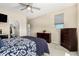 Cozy bedroom with a dresser, ceiling fan, and ample natural light at 5516 N 193Rd Ave, Litchfield Park, AZ 85340