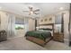 Spacious bedroom featuring a large bed, soft lighting, and window views at 5516 N 193Rd Ave, Litchfield Park, AZ 85340