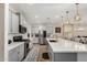 Open kitchen featuring quartz countertops, modern stainless steel appliances, and gray cabinetry at 5516 N 193Rd Ave, Litchfield Park, AZ 85340