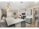 Spacious kitchen with a large center island, pendant lights, and stainless steel appliances at 5516 N 193Rd Ave, Litchfield Park, AZ 85340