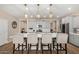Modern kitchen with a large center island, white countertops, gray cabinets, and stylish pendant lighting at 5516 N 193Rd Ave, Litchfield Park, AZ 85340