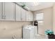 Well-equipped laundry room featuring full size washer and dryer and ample storage at 5516 N 193Rd Ave, Litchfield Park, AZ 85340