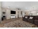 Open-concept living room with wood floors, recessed lighting, modern ceiling fan, and access to kitchen at 5516 N 193Rd Ave, Litchfield Park, AZ 85340