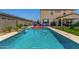 Sparkling pool in backyard surrounded by patio, fence, and lush landscaping at 5516 N 193Rd Ave, Litchfield Park, AZ 85340