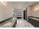 Primary bathroom with dual sinks, granite countertops, walk-in shower, soaking tub and marble floors at 7254 E Sonoran Trl, Scottsdale, AZ 85266