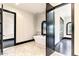 Bathroom with modern tub, marble tile, and a dark-framed window at 7254 E Sonoran Trl, Scottsdale, AZ 85266