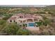 Luxury home with pool, lush landscaping, covered patio, and views at 7254 E Sonoran Trl, Scottsdale, AZ 85266