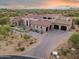 Expansive home featuring desert landscaping, red tile roof, and a spacious driveway leading to a 3-car garage at 7254 E Sonoran Trl, Scottsdale, AZ 85266