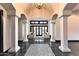 Grand foyer with soaring ceilings, columns, tile floors, and views to the outdoor living area at 7254 E Sonoran Trl, Scottsdale, AZ 85266