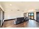 Spacious living room with hardwood floors, seating, and a large glass door leading to a view at 7254 E Sonoran Trl, Scottsdale, AZ 85266