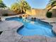 Backyard pool features a rock waterfall feature and stamped concrete surround at 7313 S 25Th S Dr, Phoenix, AZ 85041