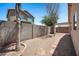 Backyard features gravel, pavers, a privacy wall, and a pergola, offering a serene outdoor space at 874 E Lamonte St, San Tan Valley, AZ 85140