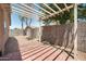 Backyard featuring a wooden pergola with brick detailing and a block wall for privacy and outdoor enjoyment at 874 E Lamonte St, San Tan Valley, AZ 85140