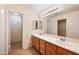 Bathroom with double sinks, a large mirror, and tile flooring at 874 E Lamonte St, San Tan Valley, AZ 85140