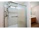 Bathroom boasts walk-in shower with safety bars and glass enclosure at 874 E Lamonte St, San Tan Valley, AZ 85140
