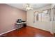 Cozy bedroom with wood floors, ceiling fan, and mirrored closet at 874 E Lamonte St, San Tan Valley, AZ 85140