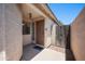 Charming front entry with a secure gate, stone accents, and covered porch adding curb appeal and security at 874 E Lamonte St, San Tan Valley, AZ 85140