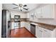 Well-equipped kitchen features stainless steel appliances, ample counter space, and sleek white cabinetry at 874 E Lamonte St, San Tan Valley, AZ 85140