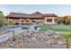 Expansive backyard with an outdoor kitchen and inviting lounge area with desert landscaping at 9183 W Shamel Ash Rd, Peoria, AZ 85383