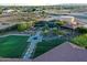 Aerial view showcasing well manicured turf, a custom fire pit and a beautiful pool at 9183 W Shamel Ash Rd, Peoria, AZ 85383