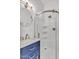 Bathroom featuring a walk-in shower with glass door and blue vanity at 9183 W Shamel Ash Rd, Peoria, AZ 85383