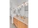 Bathroom featuring double sinks, a large mirror, and warm lighting at 9183 W Shamel Ash Rd, Peoria, AZ 85383