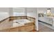 Bright bathroom with a large soaking tub and views of the bedroom at 9183 W Shamel Ash Rd, Peoria, AZ 85383