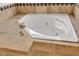 Spa-like soaking tub with tile surround and elegant fixtures at 9183 W Shamel Ash Rd, Peoria, AZ 85383