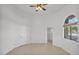 Bright bedroom with ceiling fan, neutral paint, and a view of the outside oasis at 9183 W Shamel Ash Rd, Peoria, AZ 85383