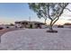 Attractive home with a circular driveway, mature landscaping, and a well-maintained exterior, exuding charm and elegance at 9183 W Shamel Ash Rd, Peoria, AZ 85383